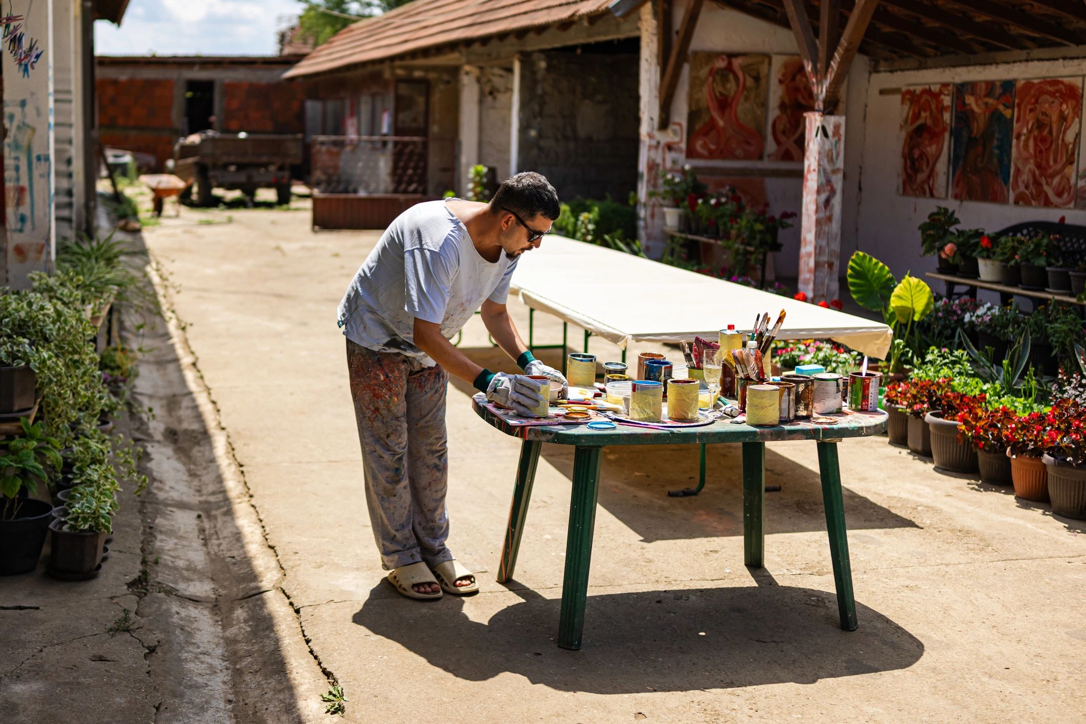 Artist preparing to paint in a calm outdoor studio setting